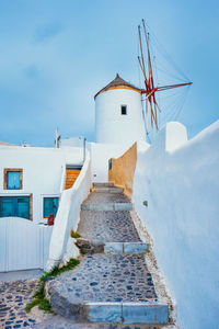 Old greek windmill on santorini island in oia town with stairs in street. santorini, greece