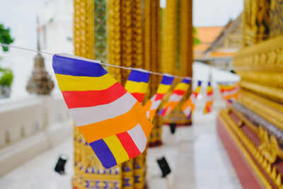 Close-up of multi colored buddhist flags hanging outside building