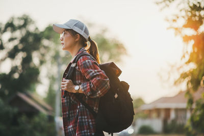 Young woman wearing hat standing outdoors