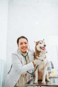 Portrait of young woman with dog