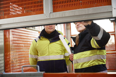 Engineers in lift at building site