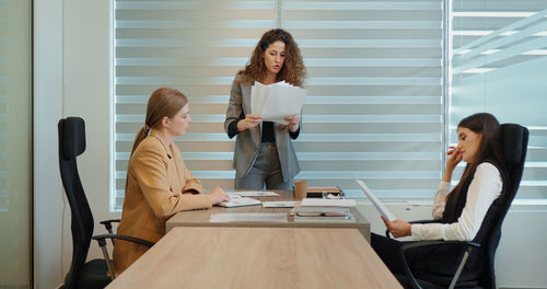 Angry buisness woman boss shouting at her employees during meeting conference leaving the room. 