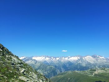 Scenic view of snowcapped mountains against clear blue sky