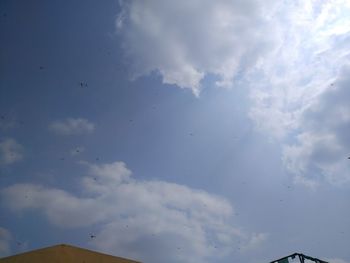 Low angle view of birds flying in sky