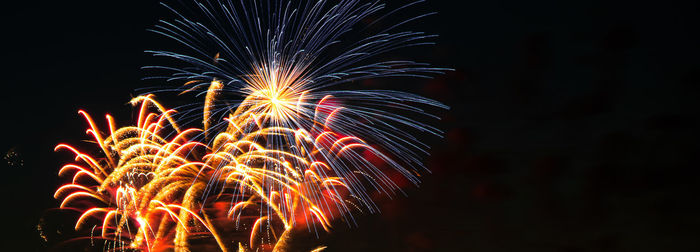 Low angle view of firework display at night