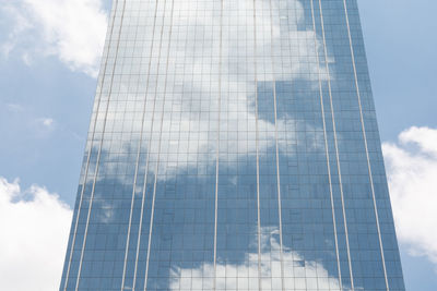 Low angle view of glass building against sky