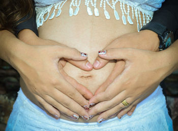 Midsection of couple with hands