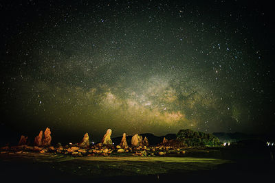 Scenic view of field against sky at night milky way