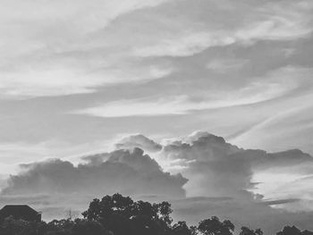 Low angle view of silhouette trees against sky
