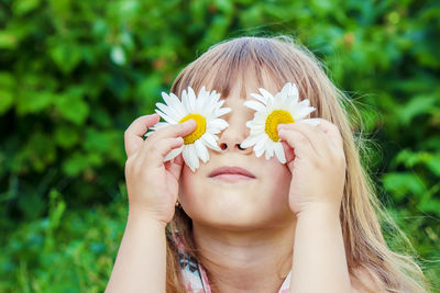 Midsection of woman holding white flower