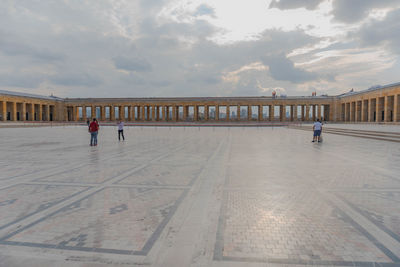 People walking on bridge against sky