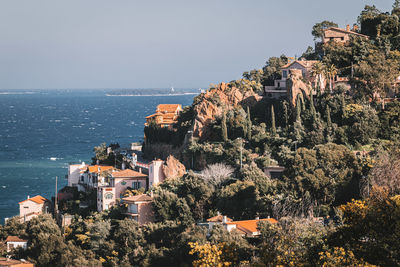 High angle view of townscape by sea against clear sky