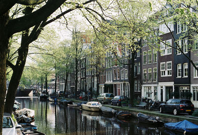 Boats moored on canal in city