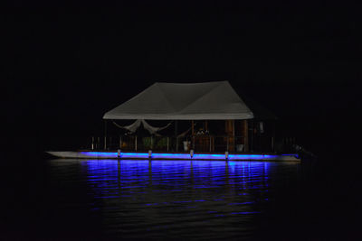 Built structure in swimming pool against clear sky at night