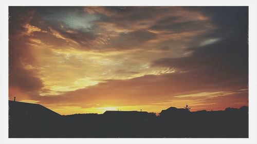 Silhouette of built structure against sunset sky