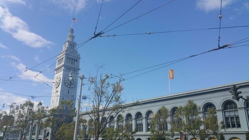 Low angle view of power lines against blue sky