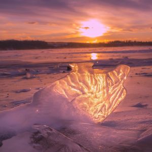Scenic view of frozen sea during sunset