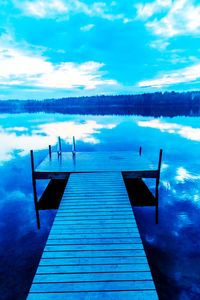 Scenic view of lake against cloudy sky