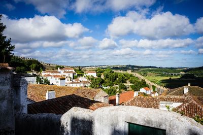 Houses in town against sky