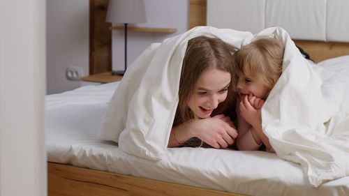 Young woman sleeping on bed at home