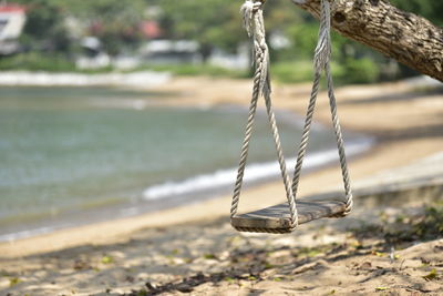 Close-up of swing on beach