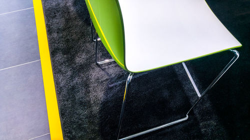 High angle view of empty chair on carpet