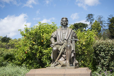 Statue in park against sky