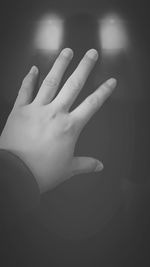 Close-up of woman hand over black background