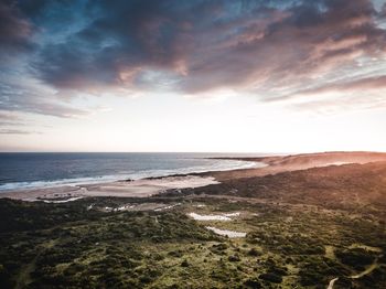 Scenic view of beach against sky during sunset