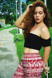 Beautiful young woman standing at park