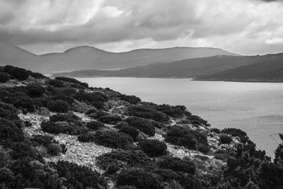 Scenic view of sea and mountains against sky