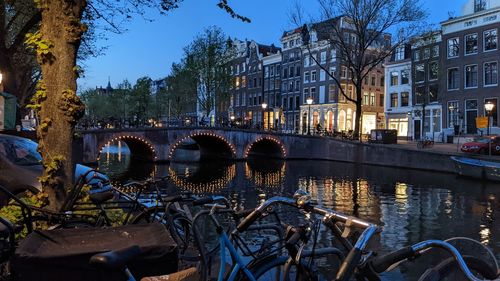 Amsterdam canal with lights around bridge