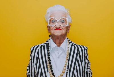 Portrait of woman against yellow background
