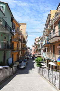 Street amidst buildings in city against sky