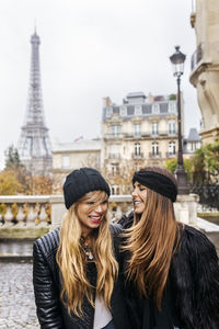 France, paris, two best friends walking down the street with the eiffel tower in the background