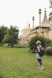 Side view of woman standing at royal pavilion