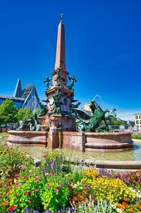 View of flowering plants against blue sky