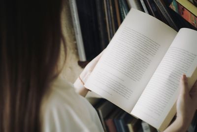 Midsection of woman reading book