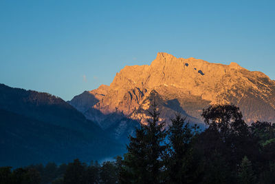 Low angle view of mountain against blue sky