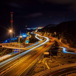 High angle view of light trails on road at night