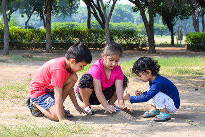 Siblings playing in park