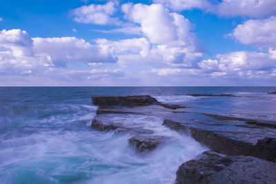 Scenic view of sea against cloudy sky