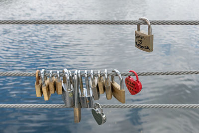 Close-up of padlocks hanging on railing