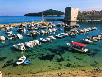 High angle view of boats moored in sea against clear sky