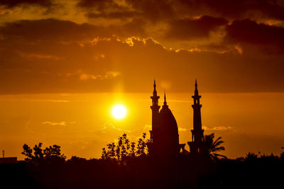 Silhouette of building against sky during sunset