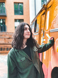 Portrait of woman standing in city during winter