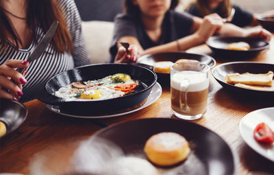 Midsection of woman preparing food on table