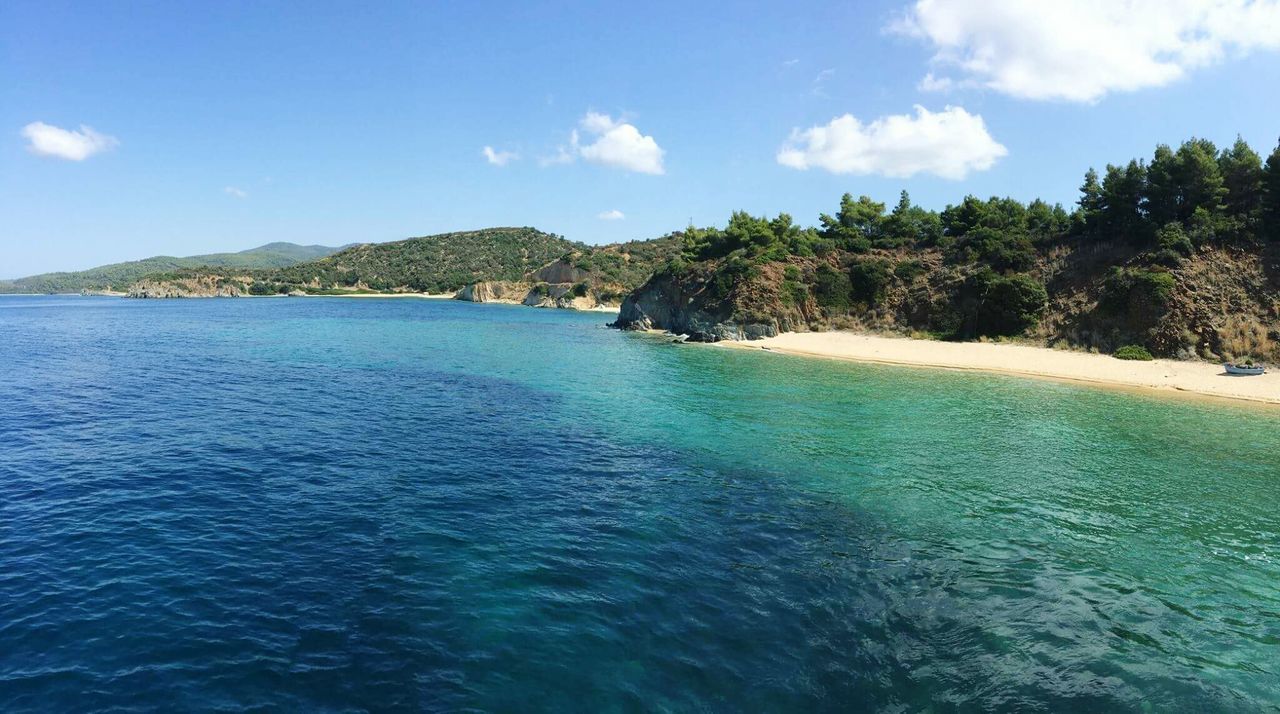 water, sky, sea, tranquil scene, scenics, blue, beauty in nature, tranquility, tree, waterfront, cloud - sky, nature, cloud, rippled, mountain, idyllic, day, beach, turquoise colored, coastline