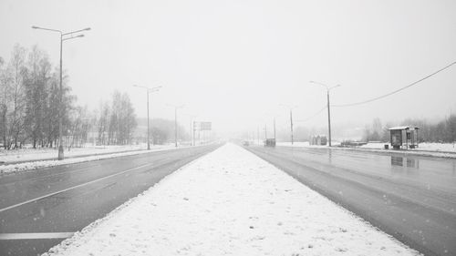 Railroad tracks against sky during winter