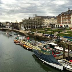 Boats in river with buildings in background